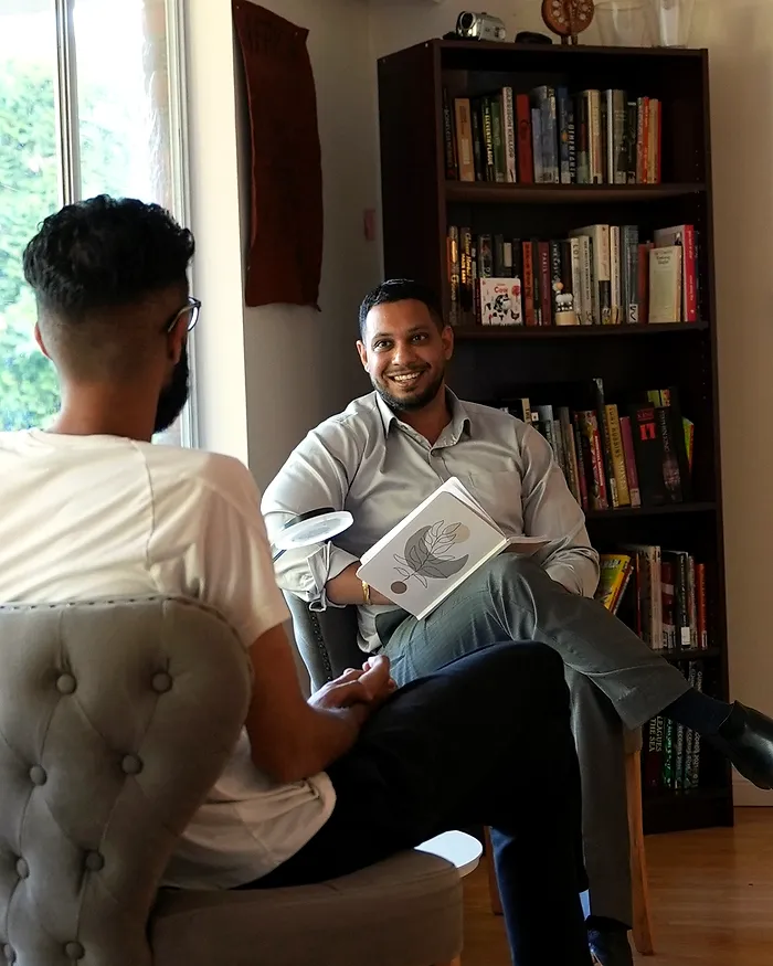 Sartaj Sandhu in conversation with a male client in the counselling room
